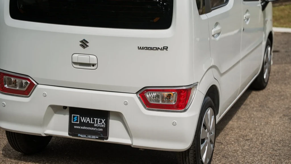 Rear three-quarter view of the white Suzuki Wagon R showing tail lights and Wagon R badge